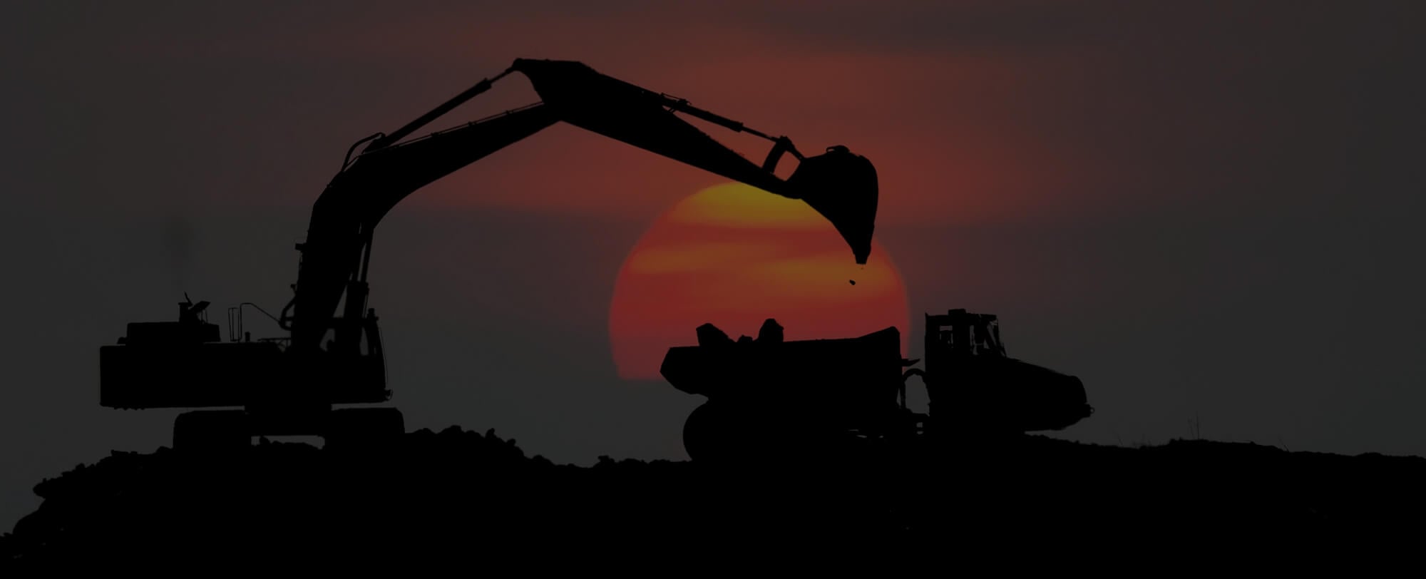 Excavator and Truck in sunset